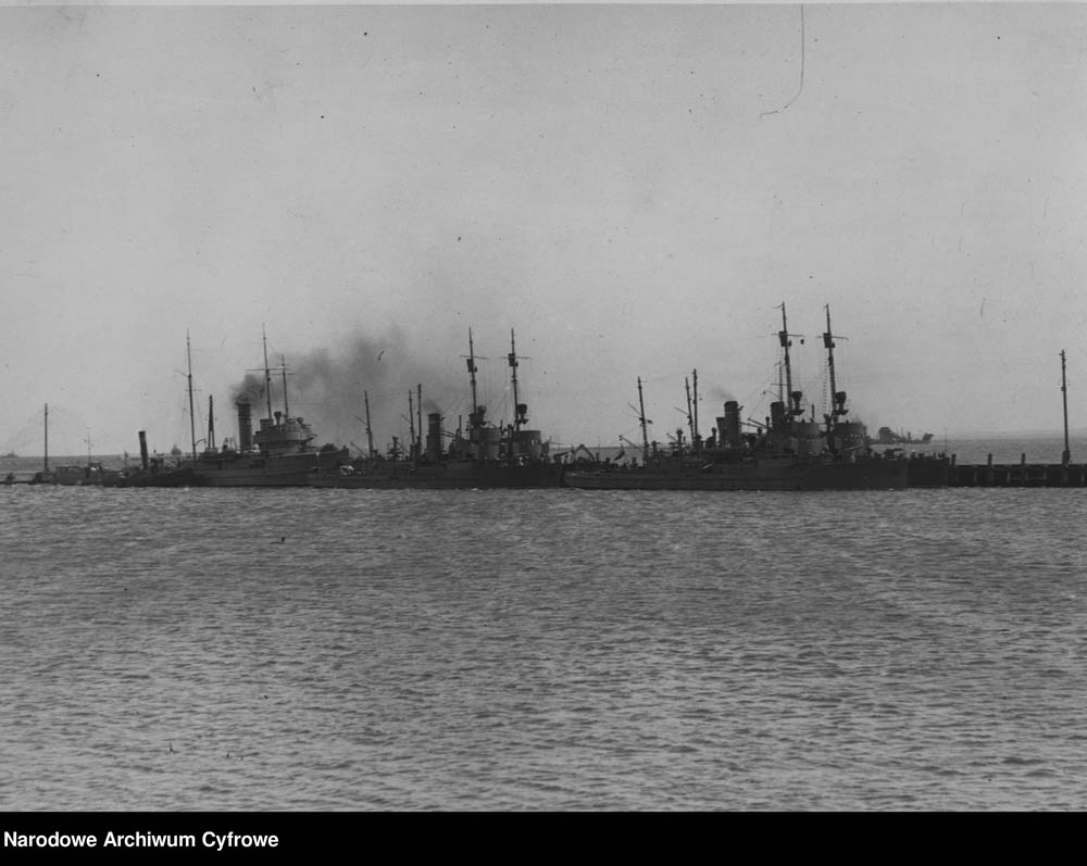[ORP GENERAŁ HALLER] Okręty Marynarki Wojennej przy gdyńskim molo. Z prawej i pośrodku dwie pary trałowców typu FM, z lewej, z dymiącym kominem ORP GENERAŁ HALLER